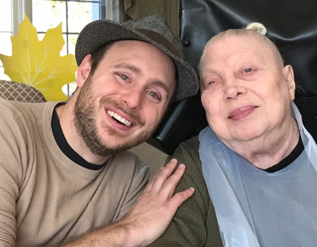 Nick with an older adult, smiling together